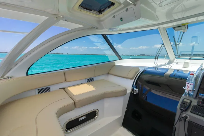 Slide: The Image of Interior of 2019 Pursuit OS 385 Offshore boat with ocean view and beige seating. - 13