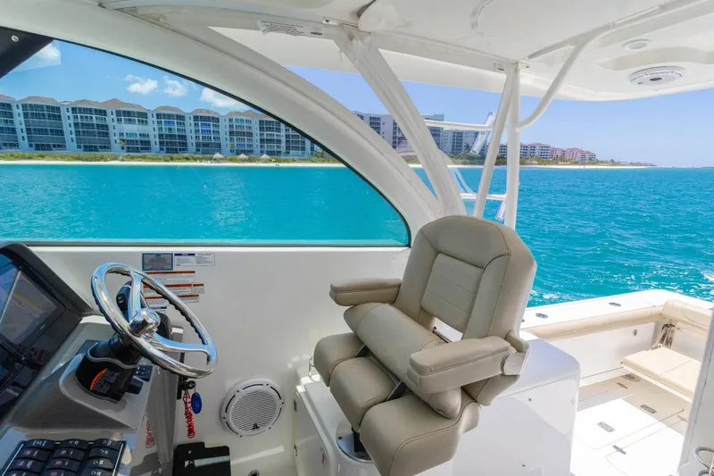 Slide: The Image of 2019 Pursuit OS 385 Offshore boat interior with ocean view and luxury seating. - 17