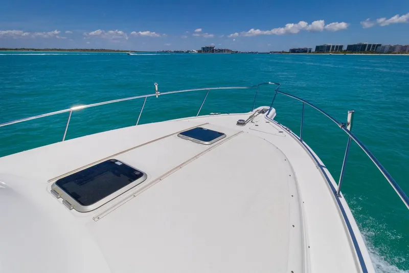 Slide: The Image of 2019 Pursuit OS 385 Offshore cruising on turquoise waters under a clear blue sky. - 21
