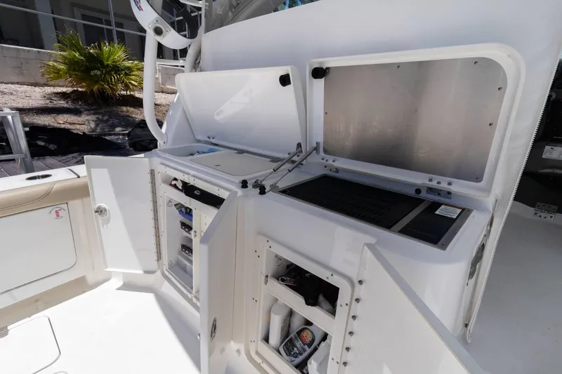 Slide: The Image of 2019 Pursuit OS 385 Offshore boat interior with open storage compartments. - 25