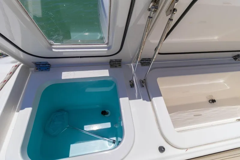 Slide: The Image of 2019 Pursuit OS 385 Offshore boat storage compartments with open lids. - 28