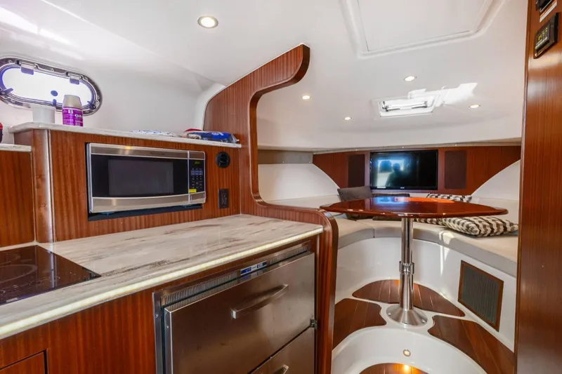 Slide: The Image of Luxurious interior of 2019 Pursuit OS 385 Offshore boat with modern kitchen and seating area. - 30