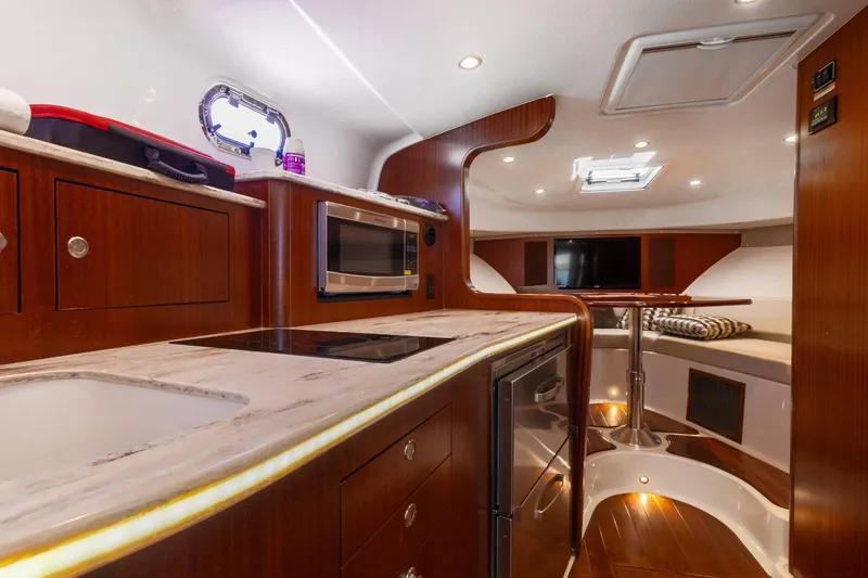 Slide: The Image of Luxurious interior of 2019 Pursuit OS 385 Offshore yacht with modern kitchen and seating area. - 31