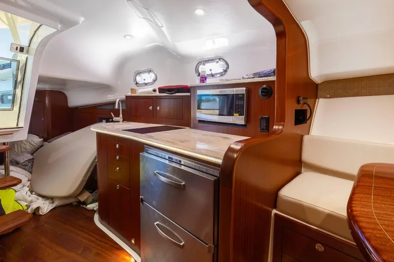 Slide: The Image of 2019 Pursuit OS 385 Offshore yacht interior with modern kitchen and seating area. - 33