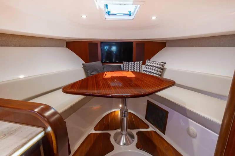 Slide: The Image of Luxurious interior of 2019 Pursuit OS 385 Offshore yacht with elegant wood table and seating. - 34