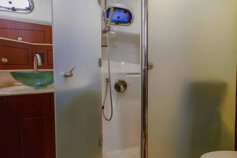Slide: The Image of 2019 Pursuit OS 385 Offshore bathroom with glass sink and shower. - 37
