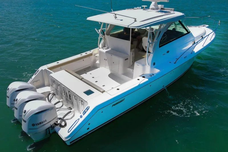 Slide: The Image of 2019 Pursuit OS 385 Offshore boat with triple Yamaha engines on blue water. - 39
