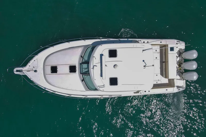 Slide: The Image of Aerial view of 2019 Pursuit OS 385 Offshore boat on clear water. - 40
