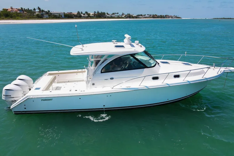 Slide: The Image of 2019 Pursuit OS 385 Offshore boat cruising on clear blue water. - 42