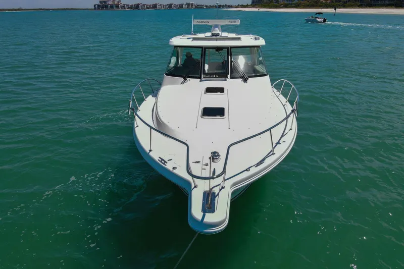 Slide: The Image of 2019 Pursuit OS 385 Offshore boat cruising on clear turquoise waters. - 47