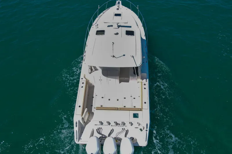 Slide: The Image of 2019 Pursuit OS 385 Offshore boat cruising on clear blue water. - 51