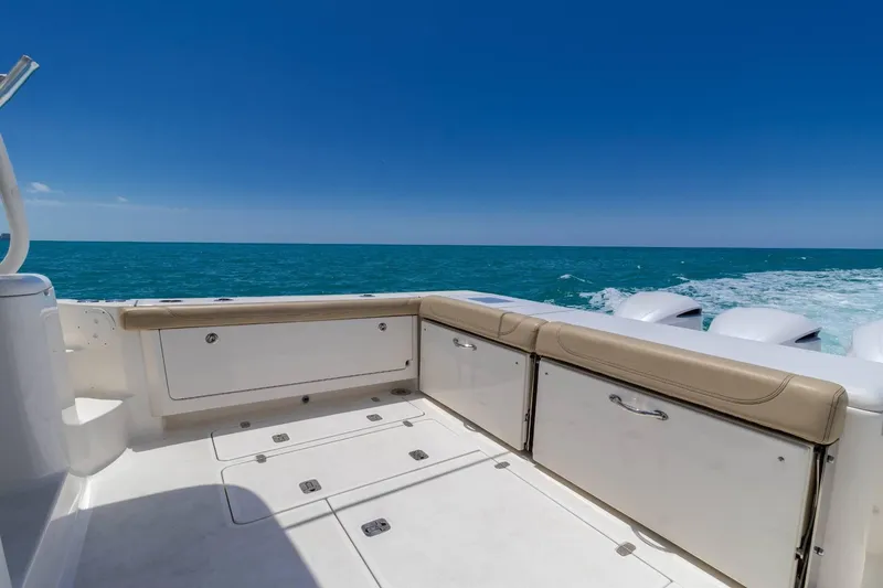 Slide: The Image of 2019 Pursuit OS 385 Offshore boat deck with ocean view and clear blue sky. - 7