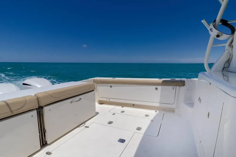 Slide: The Image of 2019 Pursuit OS 385 Offshore boat deck with ocean view under clear blue sky. - 8