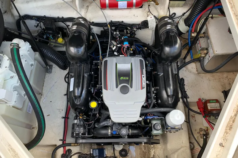 Slide: The Image of Engine compartment of a 2012 Sea Ray 240 Sundancer boat, featuring a 350 MAG engine. - 13