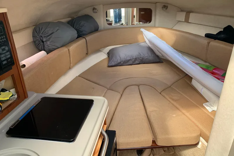 Slide: The Image of Interior cabin of a 2012 Sea Ray 240 Sundancer boat with beige seating. - 16