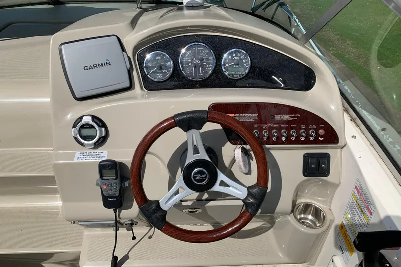 Slide: The Image of Steering console of a 2012 Sea Ray 240 Sundancer with Garmin navigation system. - 25