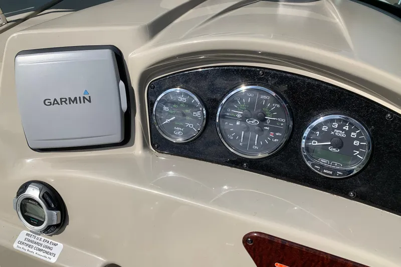 Slide: The Image of Dashboard of a 2012 Sea Ray 240 Sundancer with Garmin navigation and gauges. - 26