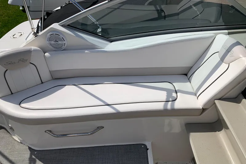 Slide: The Image of Interior seating of 2012 Sea Ray 240 Sundancer boat with white upholstery. - 28