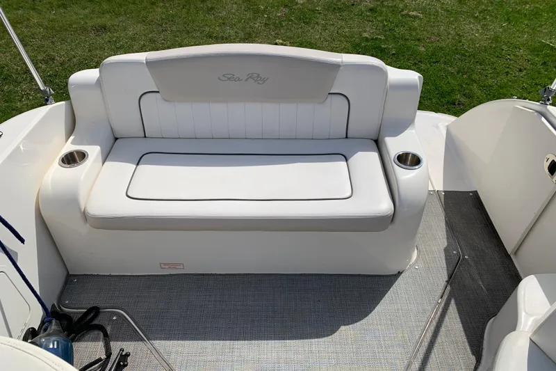 Slide: The Image of White seating area on a 2012 Sea Ray 240 Sundancer boat with cup holders. - 29