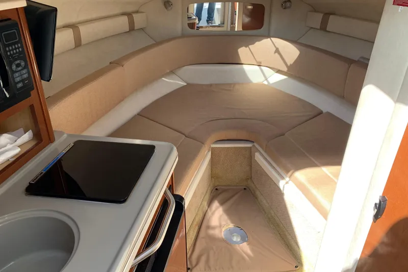 Slide: The Image of Interior cabin of 2012 Sea Ray 240 Sundancer with cozy seating and kitchenette. - 31