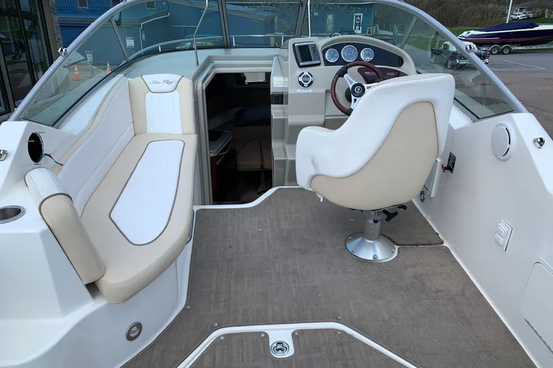 Slide: The Image of Interior view of 2012 Sea Ray 240 Sundancer boat with seating and helm. - 5