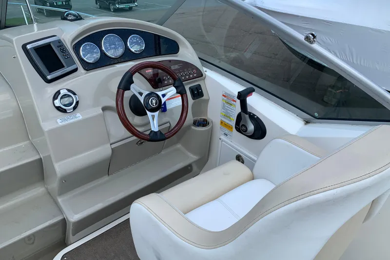 Slide: The Image of Interior cockpit of 2012 Sea Ray 240 Sundancer boat with steering wheel and controls. - 7