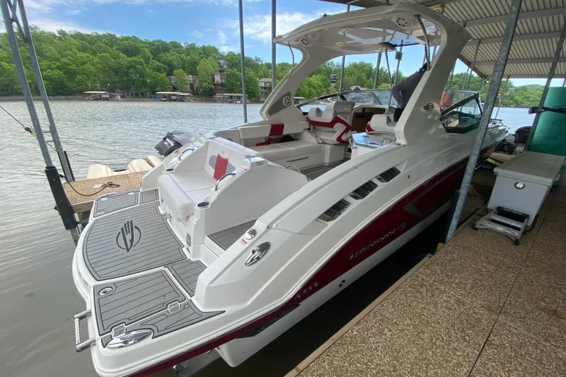 Slide: The Image of 2012 Chaparral 327 SSX boat docked, featuring sleek design and spacious seating. - 14