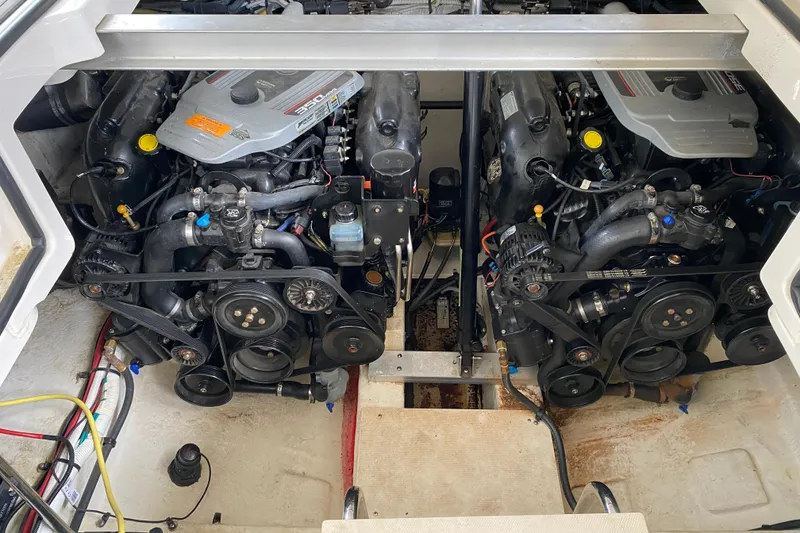 Slide: The Image of Engine compartment of a 2012 Chaparral 327 SSX boat, showcasing dual engines. - 16