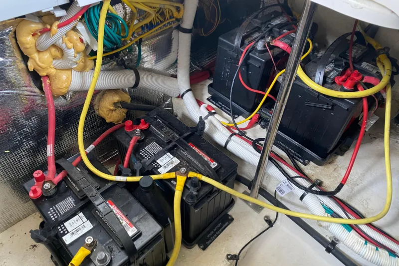 Slide: The Image of Battery compartment of a 2012 Chaparral 327 SSX boat with wiring and connections. - 18