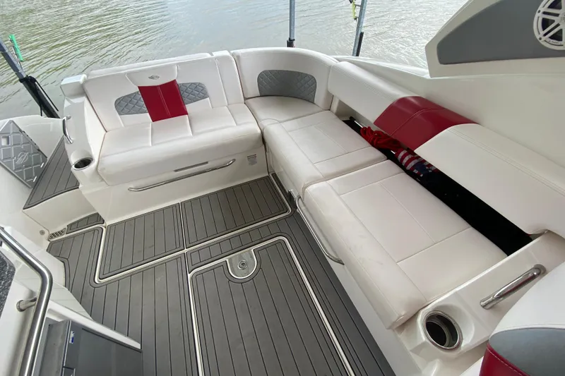 Slide: The Image of 2012 Chaparral 327 SSX boat interior with white and red seating, gray flooring. - 19
