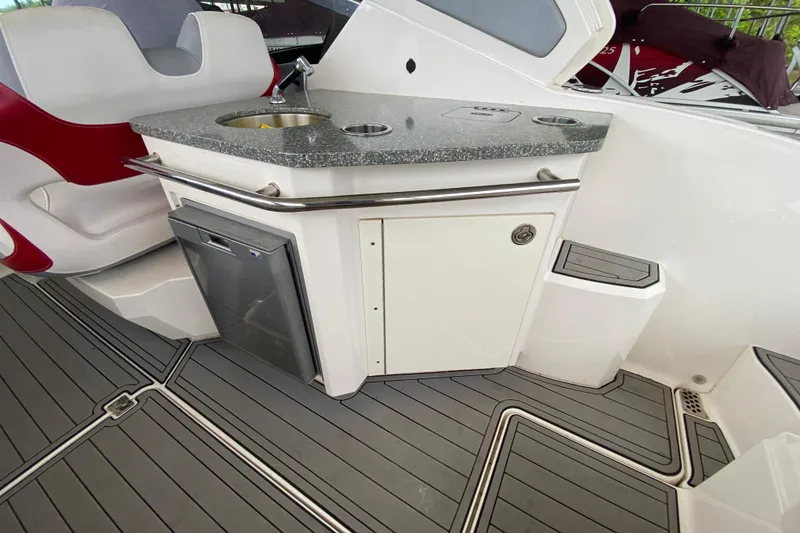 Slide: The Image of 2012 Chaparral 327 SSX boat interior with kitchenette and seating area. - 20