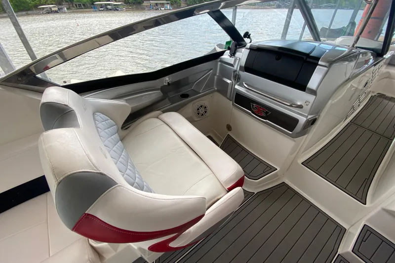 Slide: The Image of 2012 Chaparral 327 SSX boat interior with luxurious seating and modern dashboard design. - 23