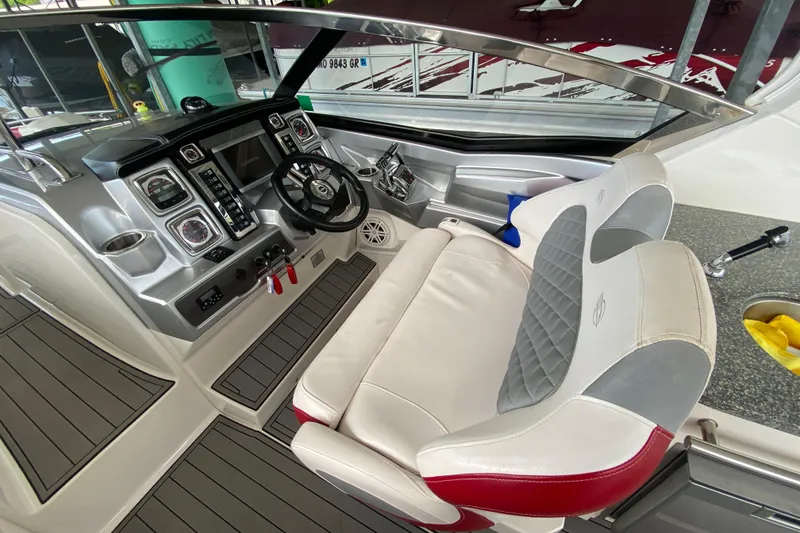 Slide: The Image of Interior view of 2012 Chaparral 327 SSX boat cockpit with modern controls and seating. - 25