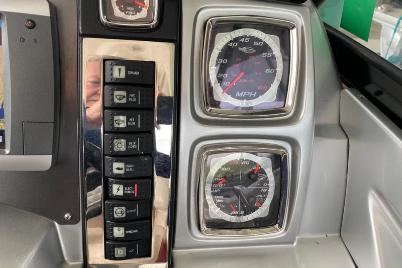 Slide: The Image of Dashboard of a 2012 Chaparral 327 SSX boat with gauges and control switches. - 29