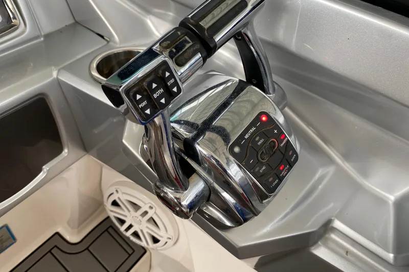 Slide: The Image of Control panel of a 2012 Chaparral 327 SSX boat with chrome throttle levers. - 31