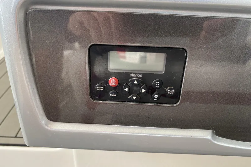 Slide: The Image of Control panel of a 2012 Chaparral 327 SSX boat featuring a Clarion audio system. - 33