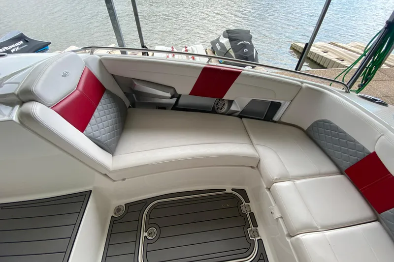 Slide: The Image of 2012 Chaparral 327 SSX boat interior with white and red seating by the water. - 36