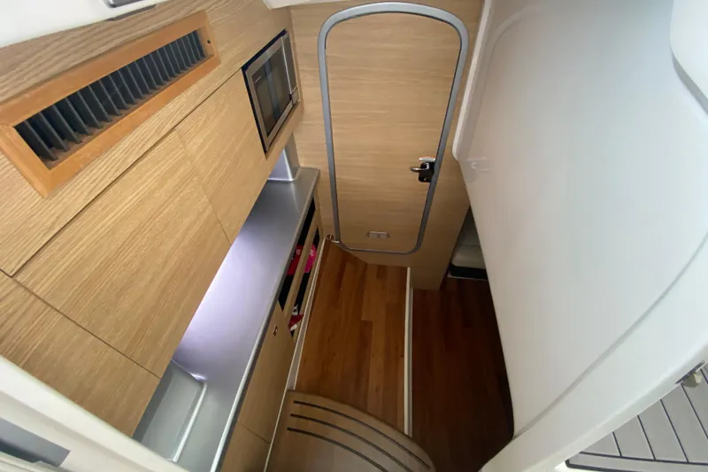 Slide: The Image of 2012 Chaparral 327 SSX cabin interior with wood finish and modern amenities. - 40