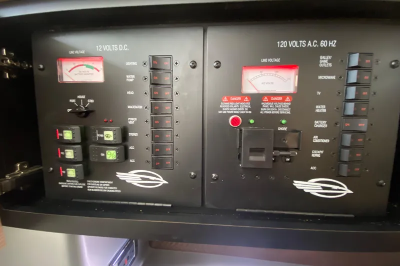 Slide: The Image of Control panel of a 2012 Chaparral 327 SSX boat, showing voltage meters and switches. - 41