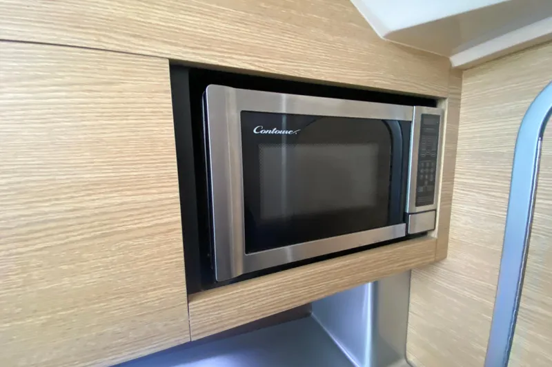Slide: The Image of Built-in microwave in 2012 Chaparral 327 SSX boat's wooden interior. - 42