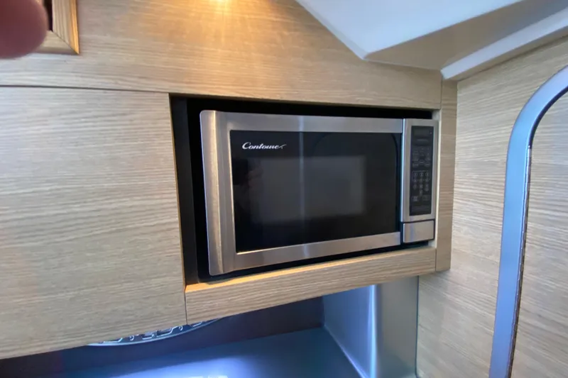 Slide: The Image of Built-in microwave in 2012 Chaparral 327 SSX boat interior. - 47