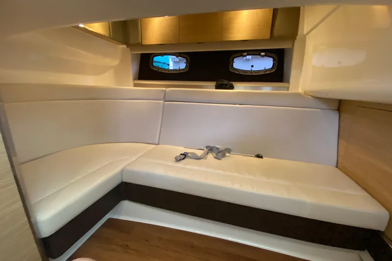 Slide: The Image of Interior of 2012 Chaparral 327 SSX boat with beige seating and wooden accents. - 48