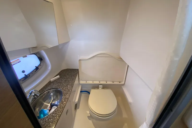 Slide: The Image of Compact bathroom in 2012 Chaparral 327 SSX boat with sink and toilet. - 50
