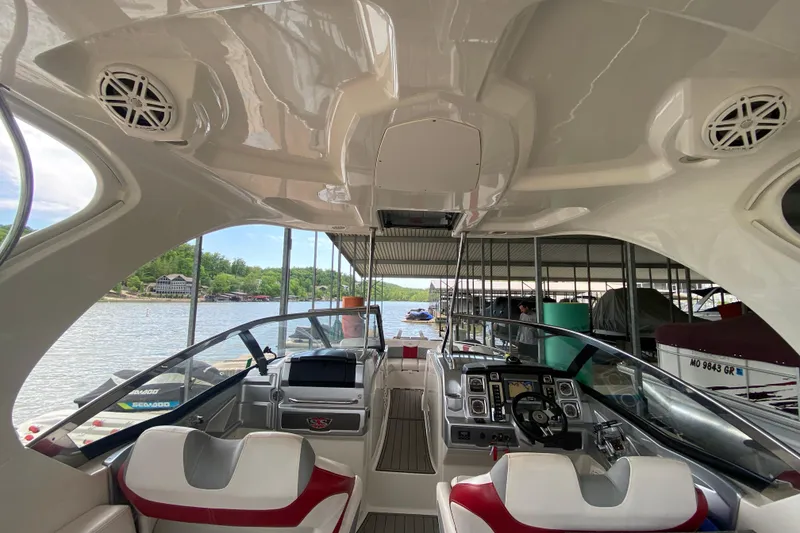 Slide: The Image of Interior view of a 2012 Chaparral 327 SSX boat docked by a lake. - 51