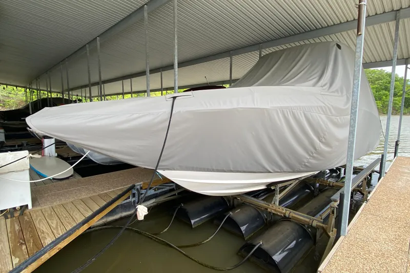 Slide: The Image of Covered 2012 Chaparral 327 SSX boat docked under a metal canopy. - 53