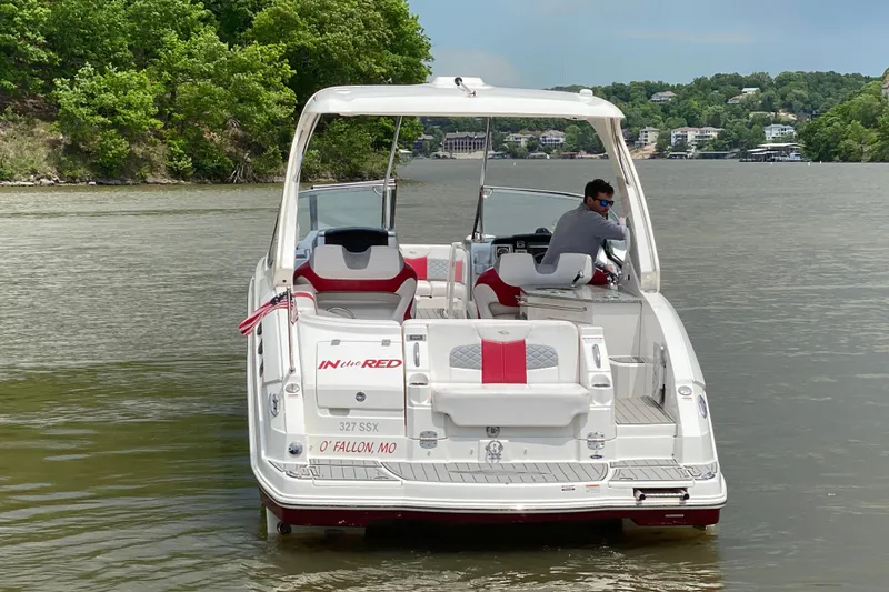 Slide: The Image of 2012 Chaparral 327 SSX boat on a lake, featuring sleek design and vibrant red accents. - 6
