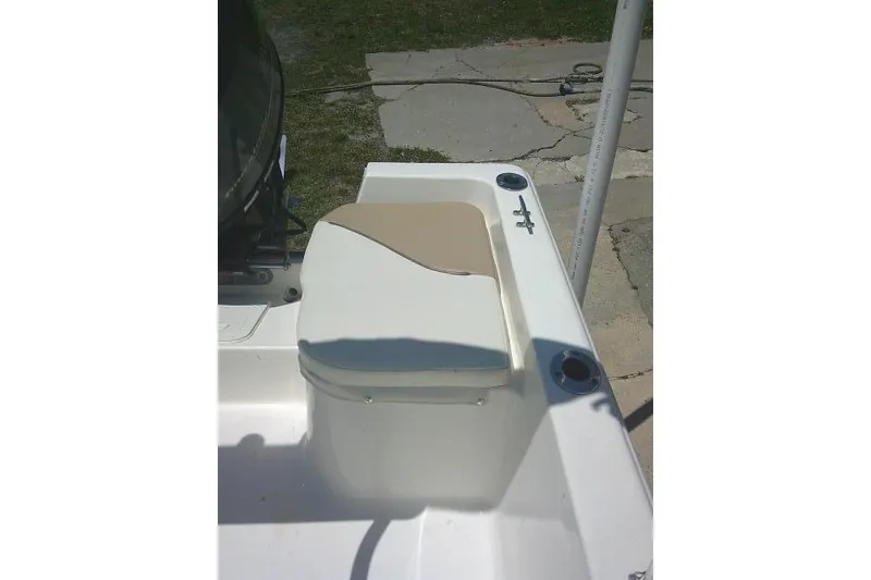 Slide: The Image of 2018 Key West 1720 Center Console boat seat with beige cushion and rod holders. - 19
