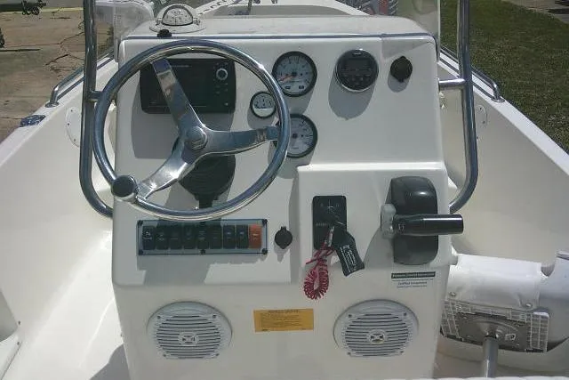 Slide: The Image of 2018 Key West 1720 Center Console boat dashboard with steering wheel and gauges. - 21