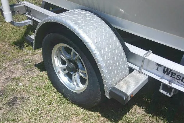 Slide: The Image of Trailer wheel of a 2018 Key West 1720 Center Console boat on grass. - 7
