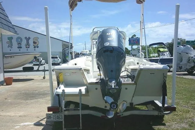 Slide: The Image of 2018 Key West 1720 Center Console boat with outboard motor, parked outdoors. - 9